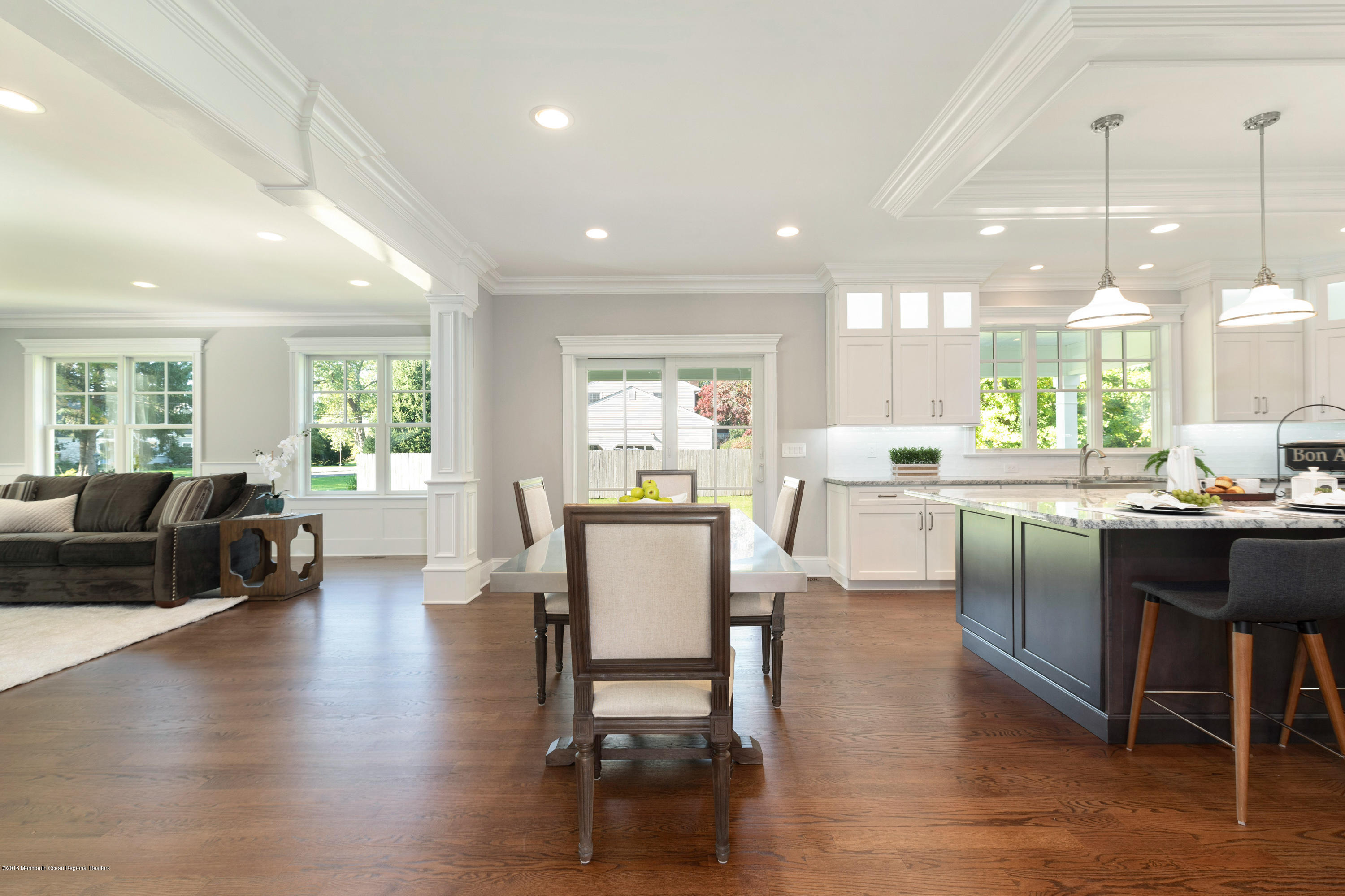 99 Rivers Edge Drive Little Silver, NJ 07739 - Photo 16 of 50 a dining room with furniture wooden floor and a kitchen view
