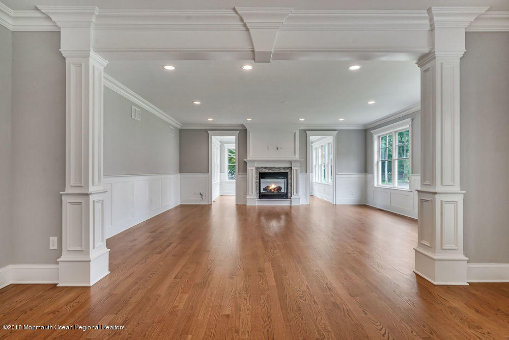 99 Rivers Edge Drive Little Silver, NJ 07739 - Photo 17 of 50 a view of empty room with wooden floor and fireplace