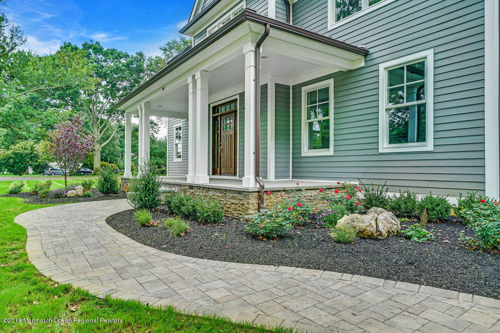 99 Rivers Edge Drive Little Silver, NJ 07739 - Photo 2 of 50 a front view of a house with garden