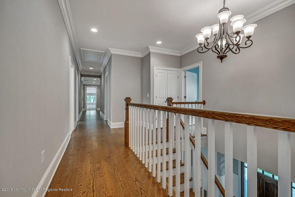 99 Rivers Edge Drive Little Silver, NJ 07739 - Photo 34 of 50 a view of a hallway with wooden floor and staircase