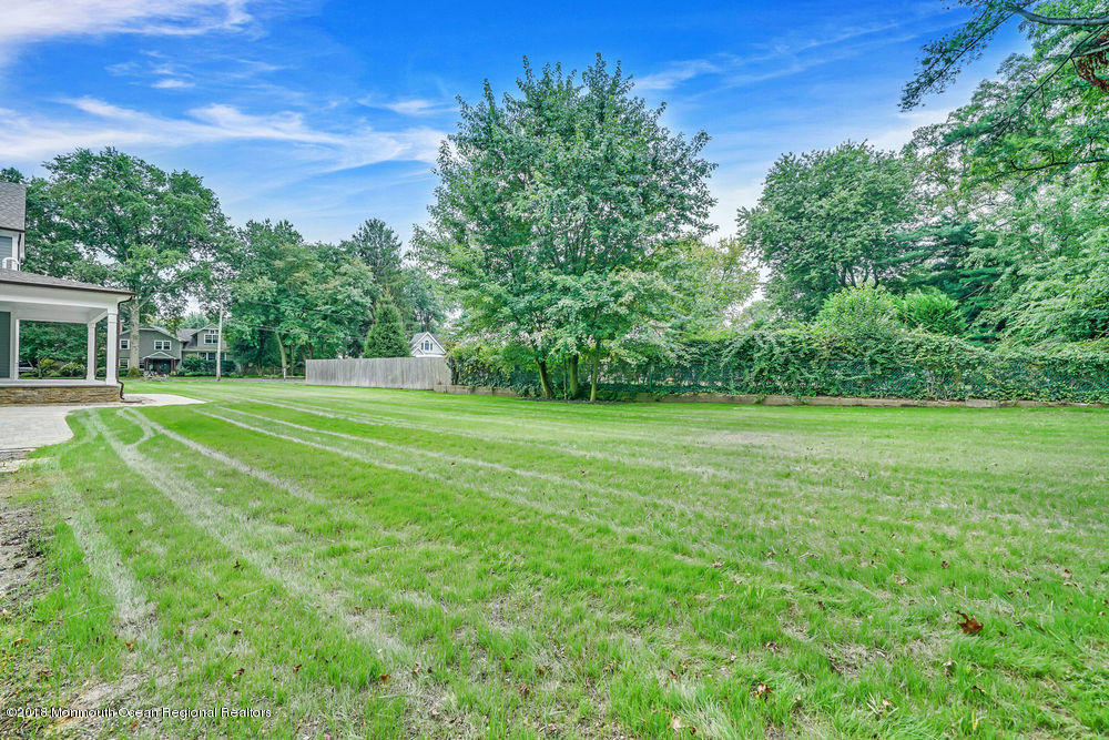 99 Rivers Edge Drive Little Silver, NJ 07739 - Photo 46 of 50 a view of a green field with wooden fence