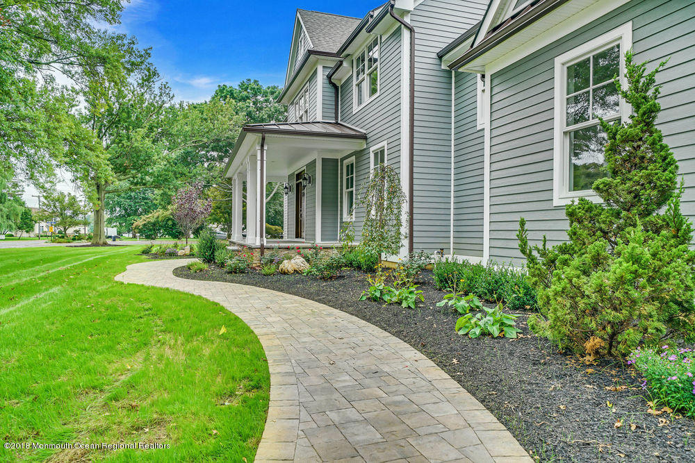 99 Rivers Edge Drive Little Silver, NJ 07739 - Photo 49 of 50 a front view of a house with a yard and potted plants