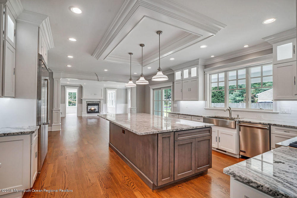 99 Rivers Edge Drive Little Silver, NJ 07739 - Photo 5 of 50 a kitchen with stainless steel appliances granite countertop a sink stove and refrigerator