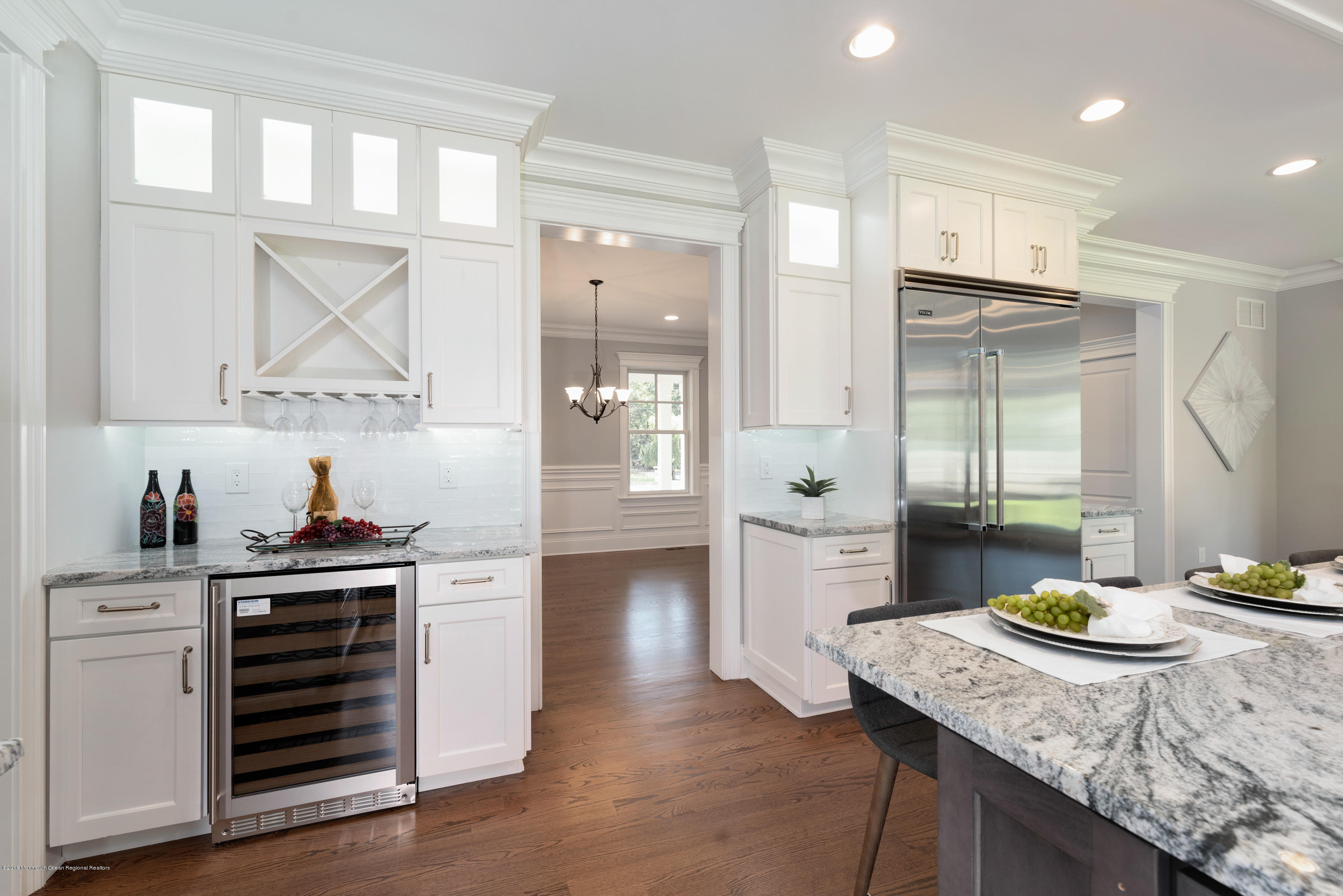 99 Rivers Edge Drive Little Silver, NJ 07739 - Photo 9 of 50 a kitchen with a table chairs refrigerator and cabinets