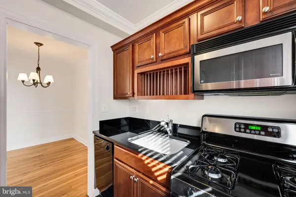 a kitchen with stainless steel appliances granite countertop a stove and a microwave