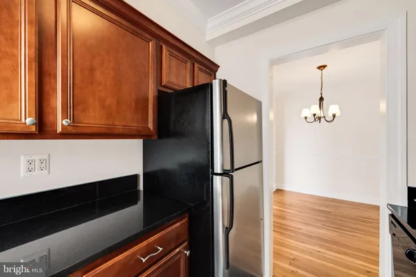 a kitchen with stainless steel appliances a refrigerator and cabinets