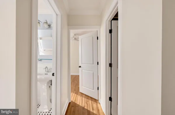 a view of a hallway with wooden floor and entryway