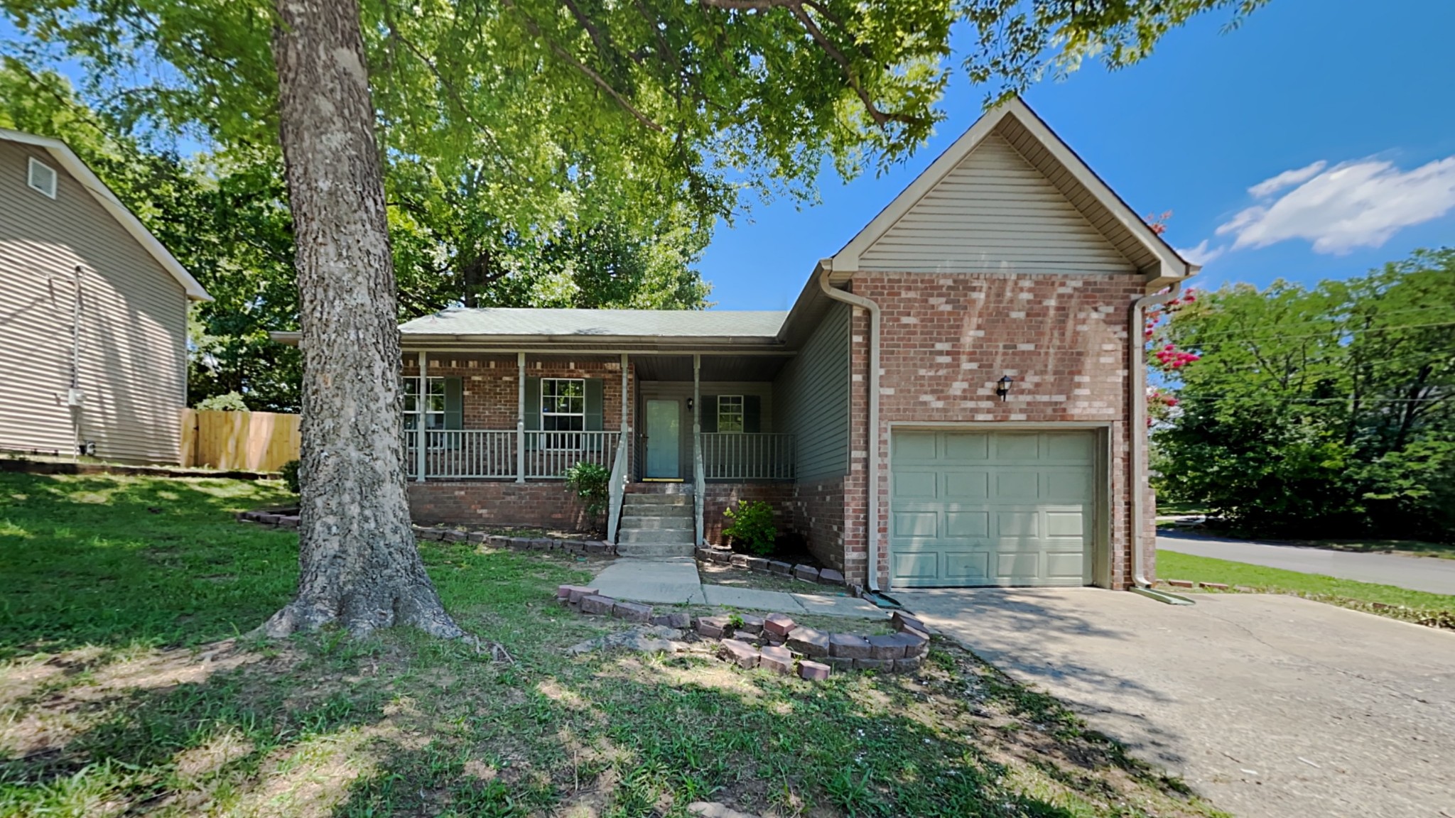 728 Bishopsgate Road Antioch, TN 37013 - Photo 1 of 15 a front view of a house with garden