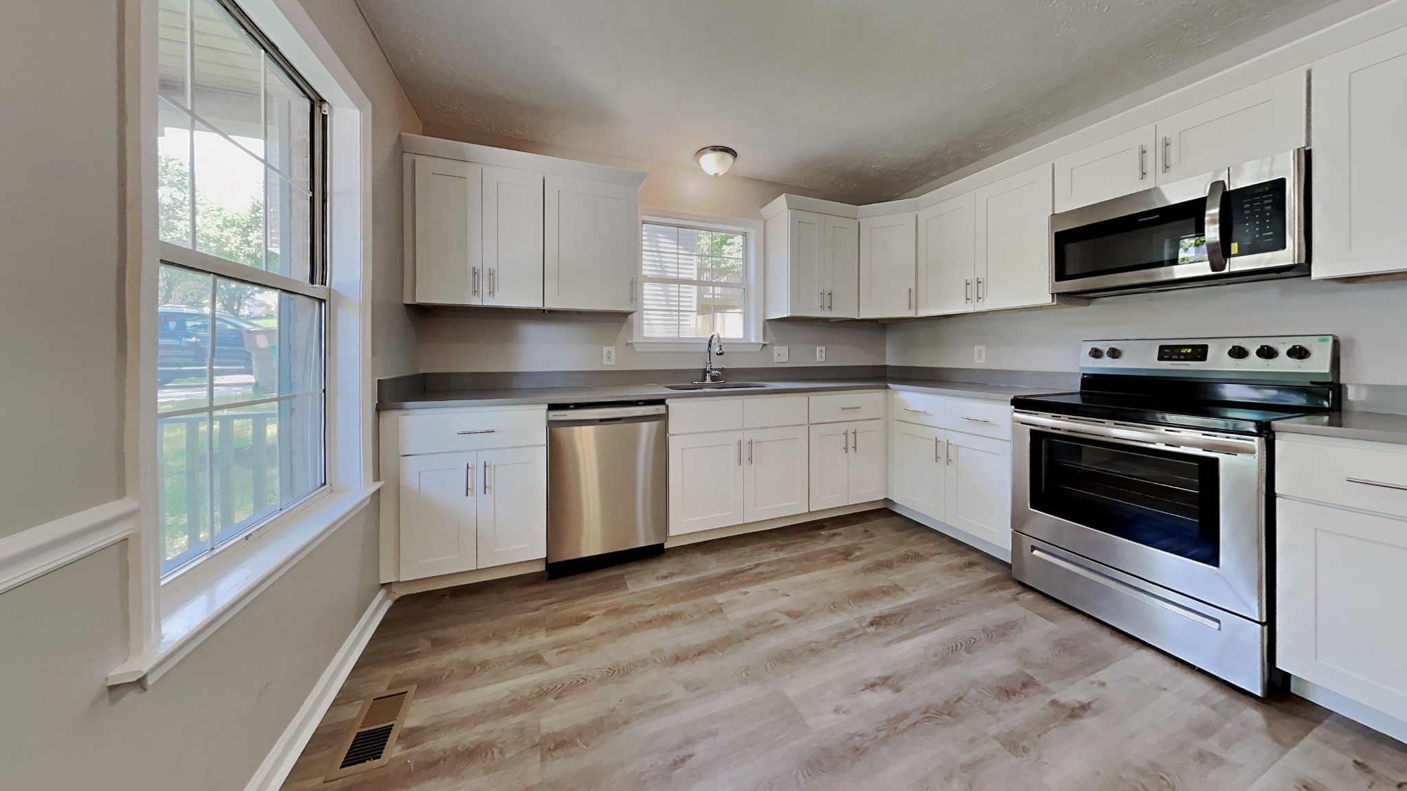728 Bishopsgate Road Antioch, TN 37013 - Photo 4 of 15 a kitchen with stainless steel appliances granite countertop a stove a sink and a microwave