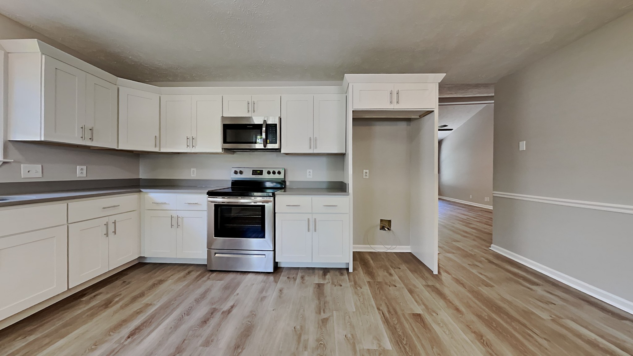 728 Bishopsgate Road Antioch, TN 37013 - Photo 5 of 15 a kitchen with wooden floors and white appliances