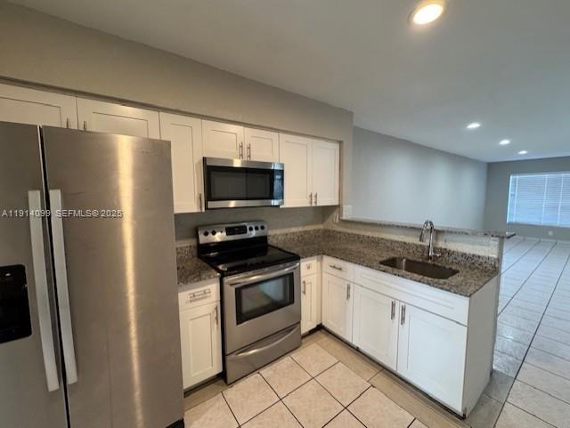 260 Southwest 8th Avenue, Unit B Hallandale Beach, FL 33009 - Photo 1 of 23 a kitchen with stainless steel appliances granite countertop a refrigerator sink and stove