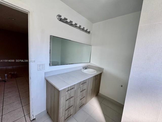 260 Southwest 8th Avenue, Unit B Hallandale Beach, FL 33009 - Photo 11 of 23 a bathroom with a sink a mirror and a vanity