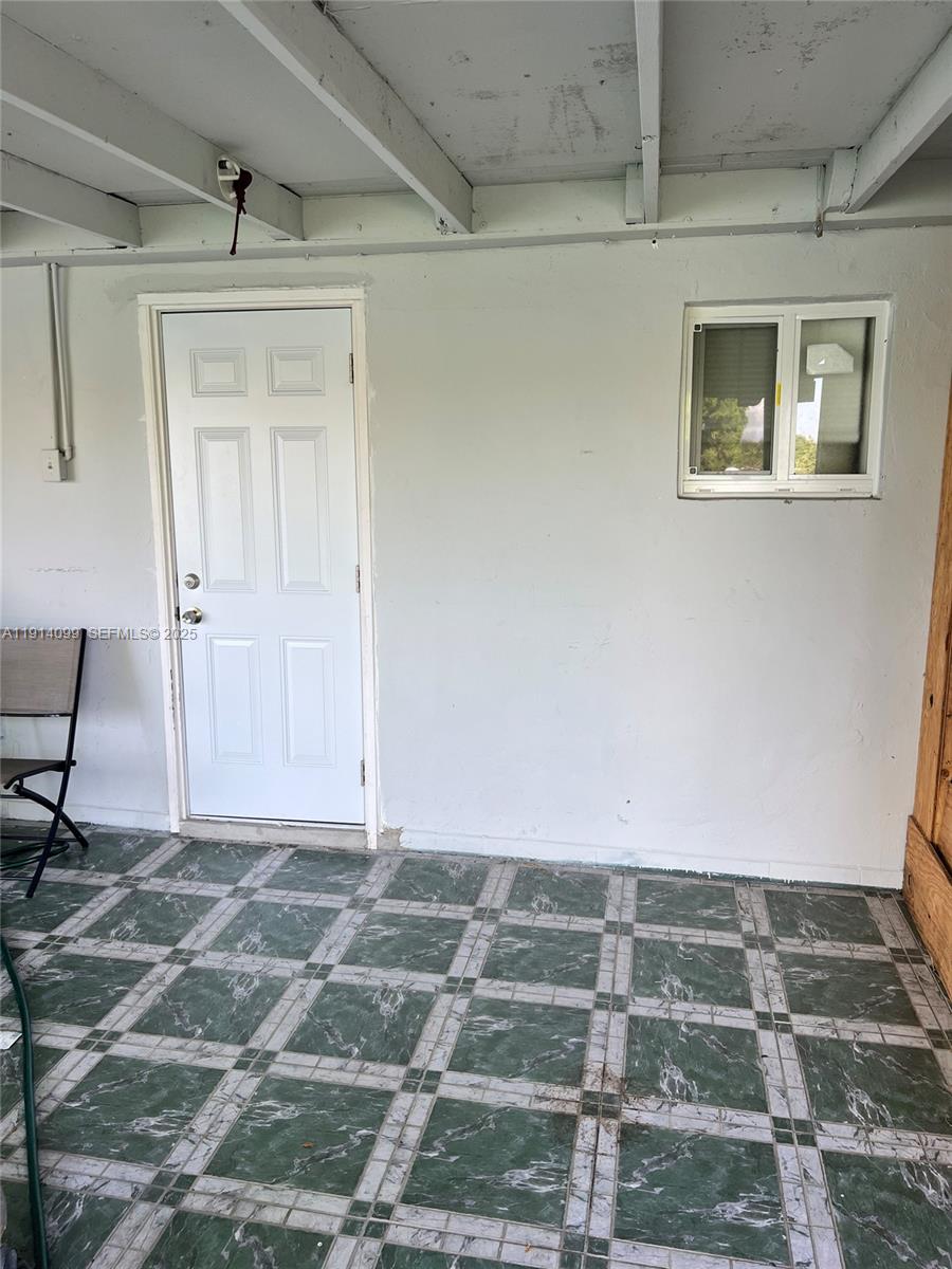 260 Southwest 8th Avenue, Unit B Hallandale Beach, FL 33009 - Photo 19 of 23 a view of a livingroom with wooden floor and a window