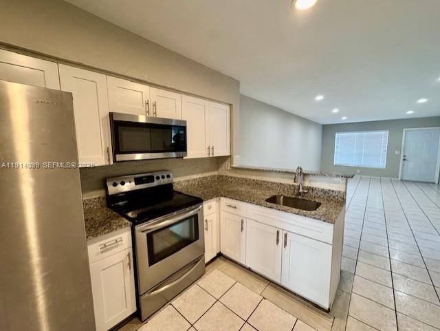 260 Southwest 8th Avenue, Unit B Hallandale Beach, FL 33009 - Photo 4 of 23 a kitchen with stainless steel appliances granite countertop a stove a sink and a microwave