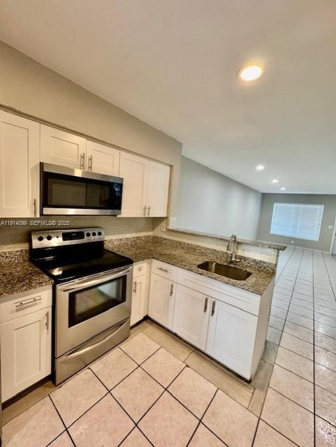 260 Southwest 8th Avenue, Unit B Hallandale Beach, FL 33009 - Photo 5 of 23 a large kitchen with granite countertop a stove and a sink