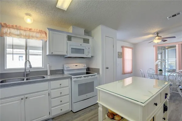 a kitchen with a stove a sink and a refrigerator