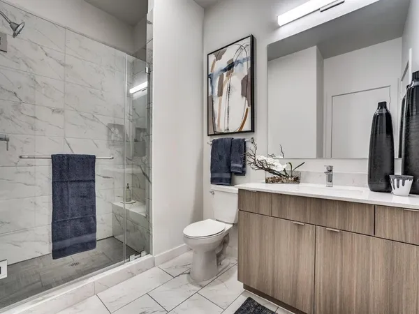 a bathroom with a sink toilet and shower