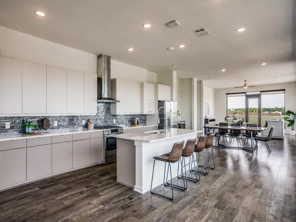 a kitchen with lots of counter top space and furniture