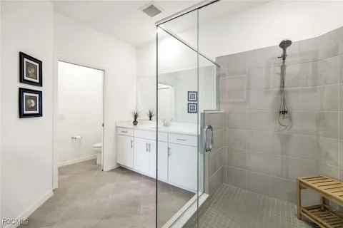 a spacious bathroom with a granite countertop sink a toilet and shower