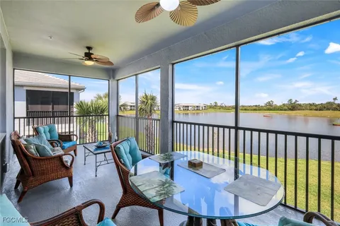 a dining room with furniture a chandelier and glass door