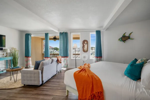 a bedroom with furniture and a large window