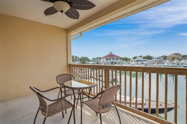 a view of a chairs and table in the balcony