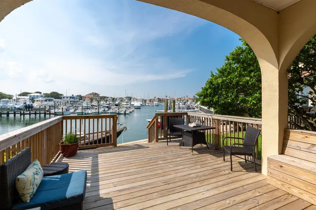 a view of a balcony with wooden floor and seating space
