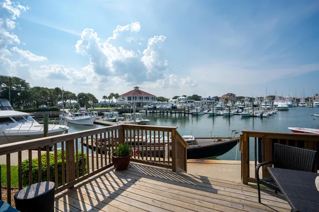 a balcony with wooden floor and lake view