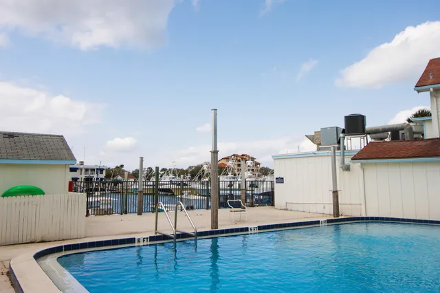 a view of a living room and kitchen with furniture and wooden floor