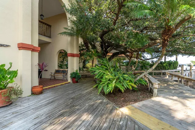 a view of a street with potted plants