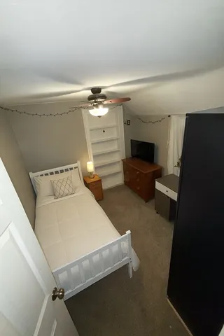a view of a livingroom with a ceiling fan and window