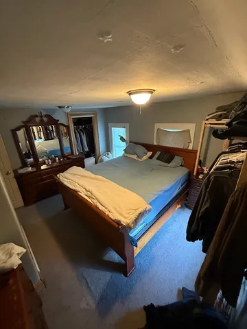 a view of empty field with trees in the background