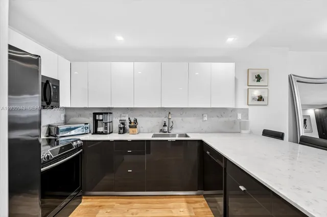 a kitchen with a sink a stove and refrigerator