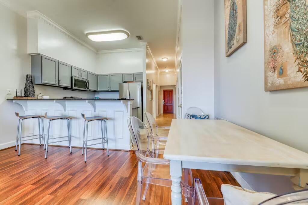 10343 East County Highway 30A, Unit 328 Inlet Beach, FL 32413 - Photo 3 of 16 a kitchen with stainless steel appliances a dining table chairs and sink