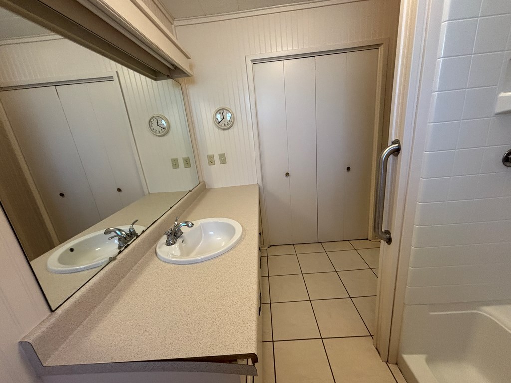 306 South Broadway Street Rocksprings, TX 78880 - Photo 16 of 23 a bathroom with a granite countertop sink a mirror and shower