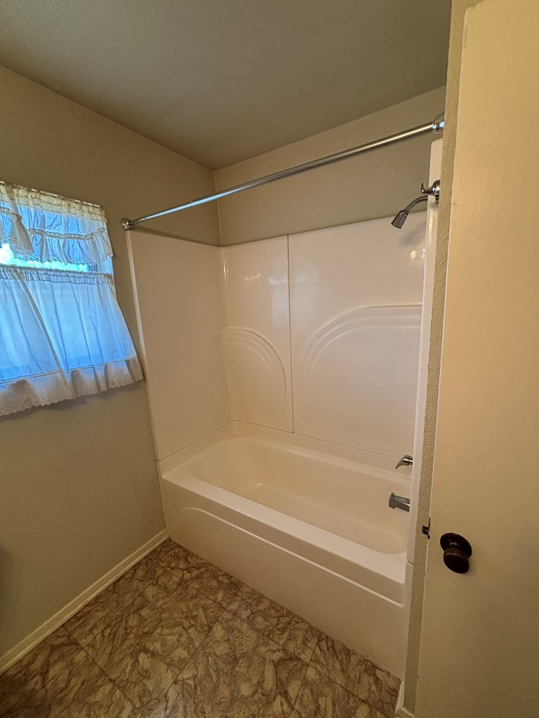 306 South Broadway Street Rocksprings, TX 78880 - Photo 23 of 23 a bathroom with a bathtub and a shower