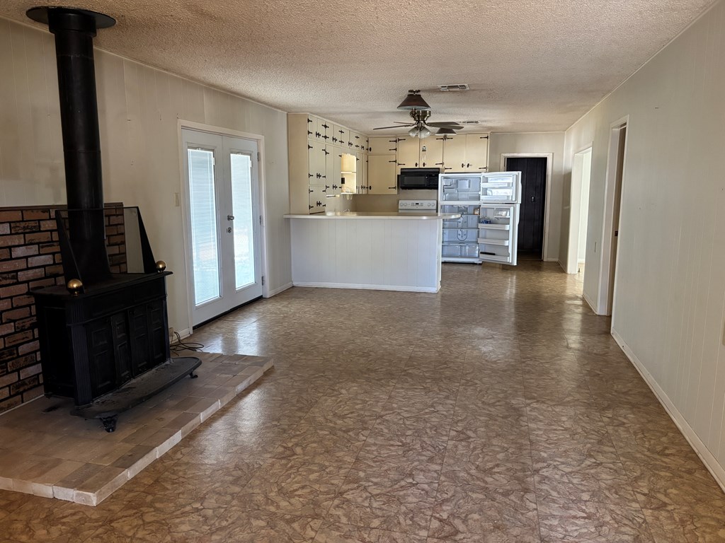306 South Broadway Street Rocksprings, TX 78880 - Photo 6 of 23 a view of a kitchen with refrigerator and a stove top oven