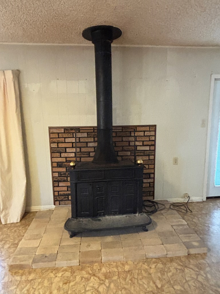 306 South Broadway Street Rocksprings, TX 78880 - Photo 7 of 23 a view of fireplace with wooden floor