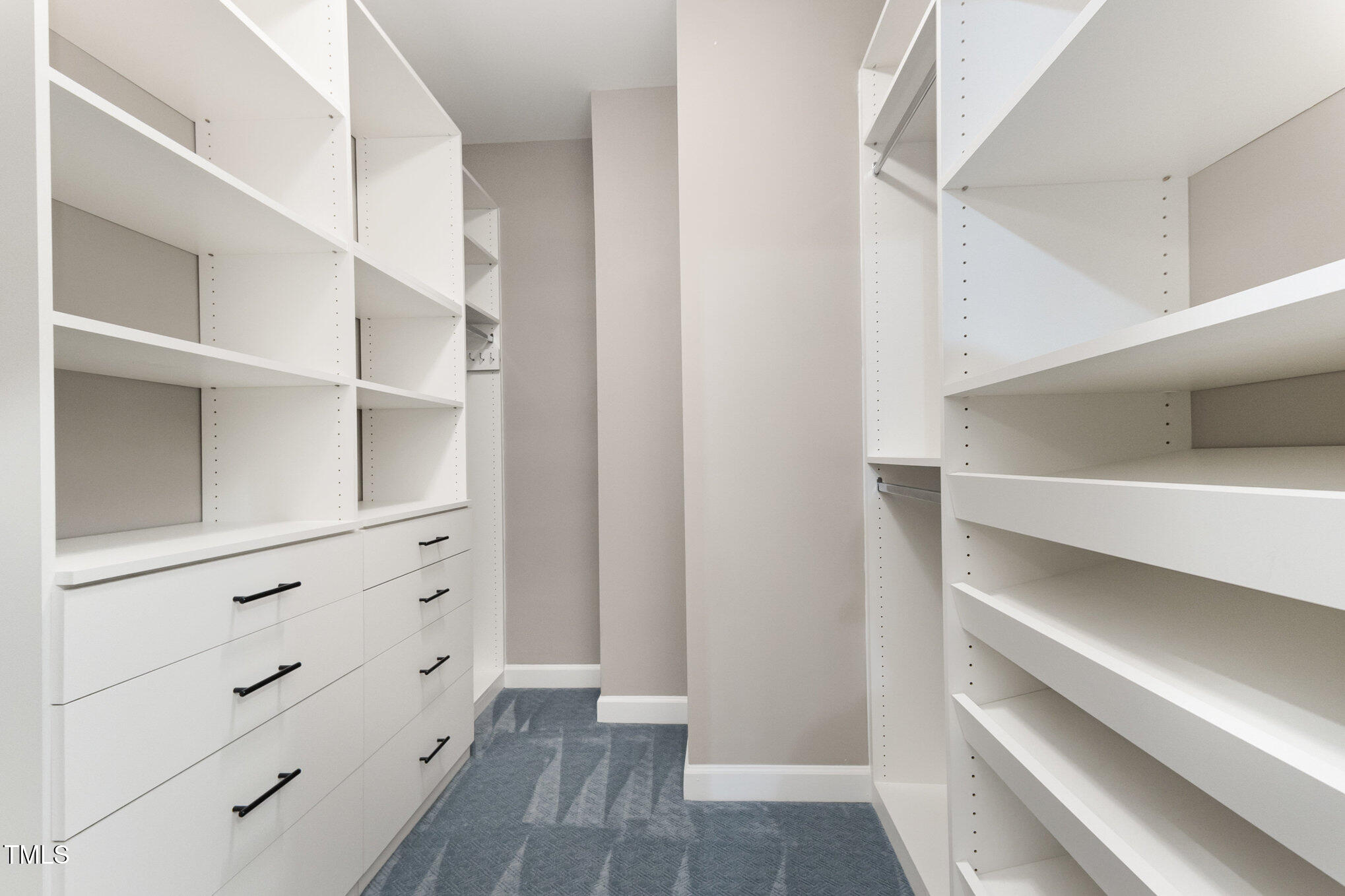 8004 Thrush Ridge Lane Raleigh, NC 27615 - Photo 20 of 34 Primary bedroom closet with custom cabinets for a ton of additional storage!