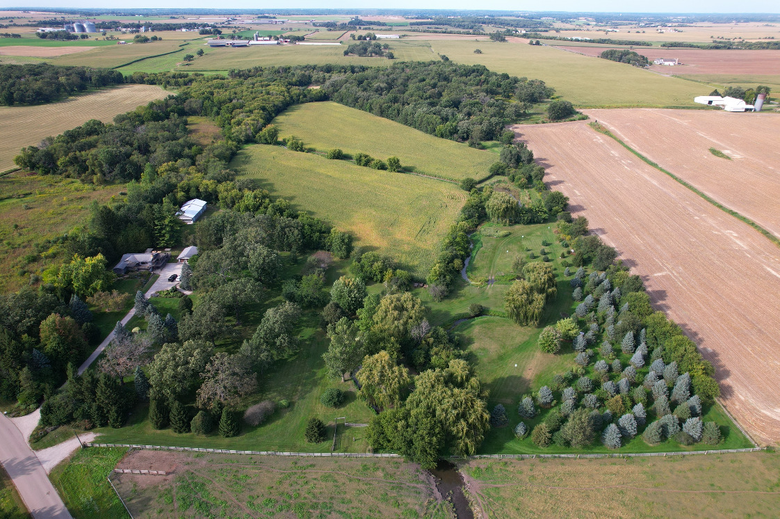 an aerial view of a house with a yard