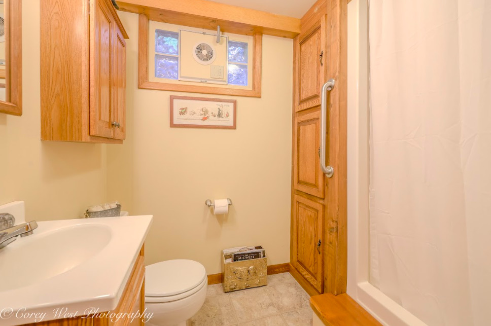 14028 Nichols Road Hebron, IL 60034 - Photo 33 of 94 a bathroom with a sink a toilet and shower curtain