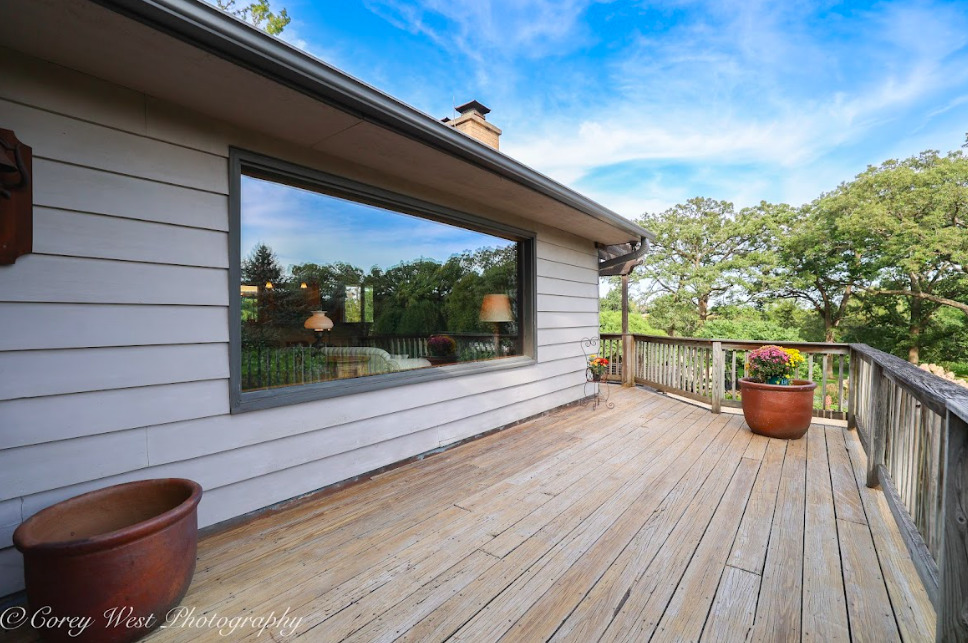 14028 Nichols Road Hebron, IL 60034 - Photo 45 of 94 a balcony with wooden floor and outdoor seating