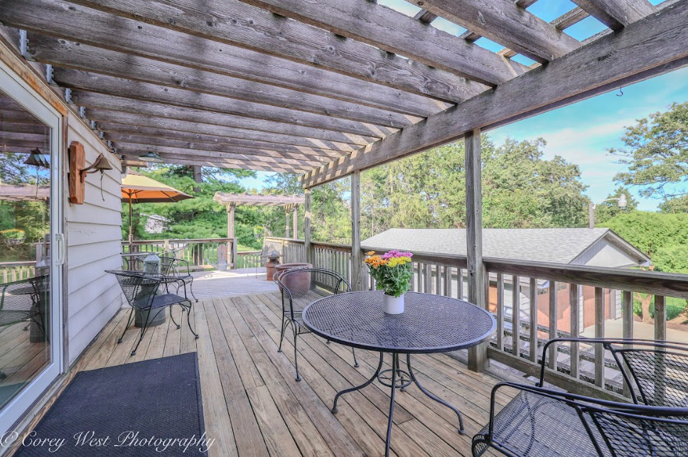 14028 Nichols Road Hebron, IL 60034 - Photo 46 of 94 a view of a patio with a table chairs and wooden floor