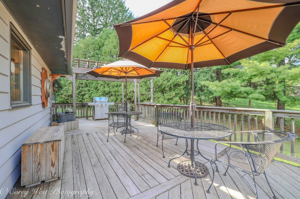 14028 Nichols Road Hebron, IL 60034 - Photo 48 of 94 a view of a balcony with chairs and umbrella