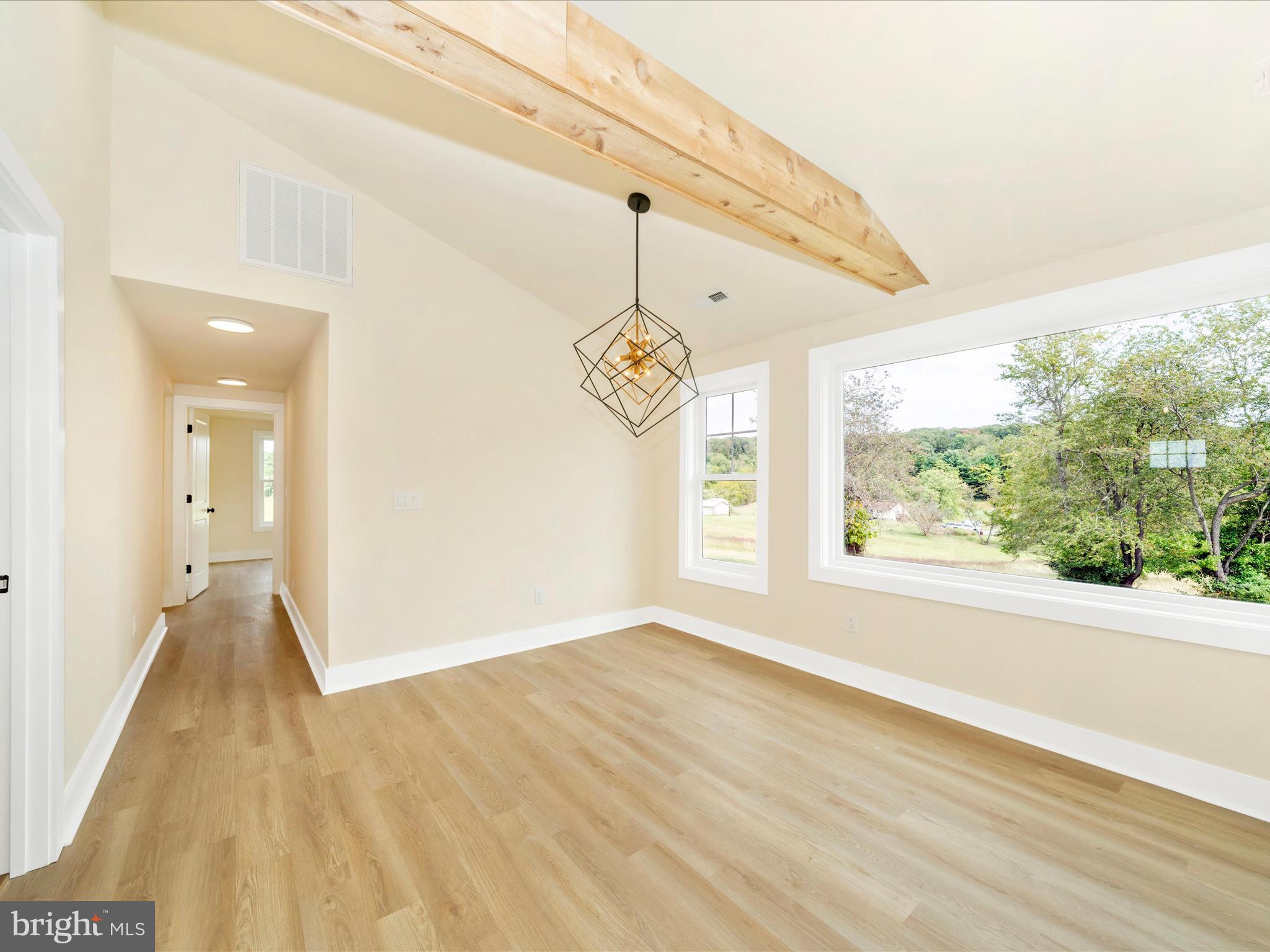 14901 New Windsor Road New Windsor, MD 21776 - Photo 15 of 75 a view of an empty room with wooden floor and a window