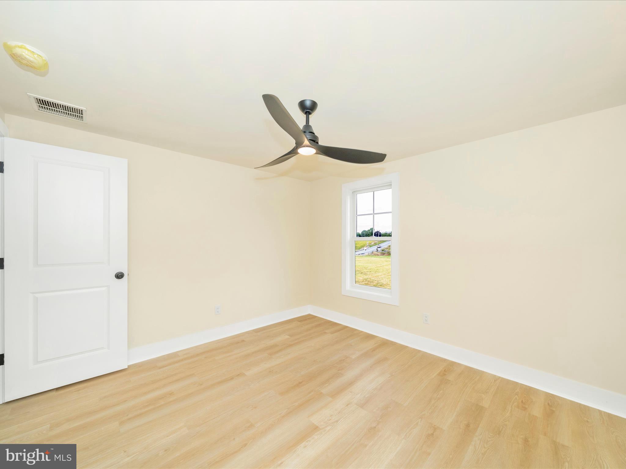 14901 New Windsor Road New Windsor, MD 21776 - Photo 21 of 75 a view of a room with wooden floor and a ceiling fan