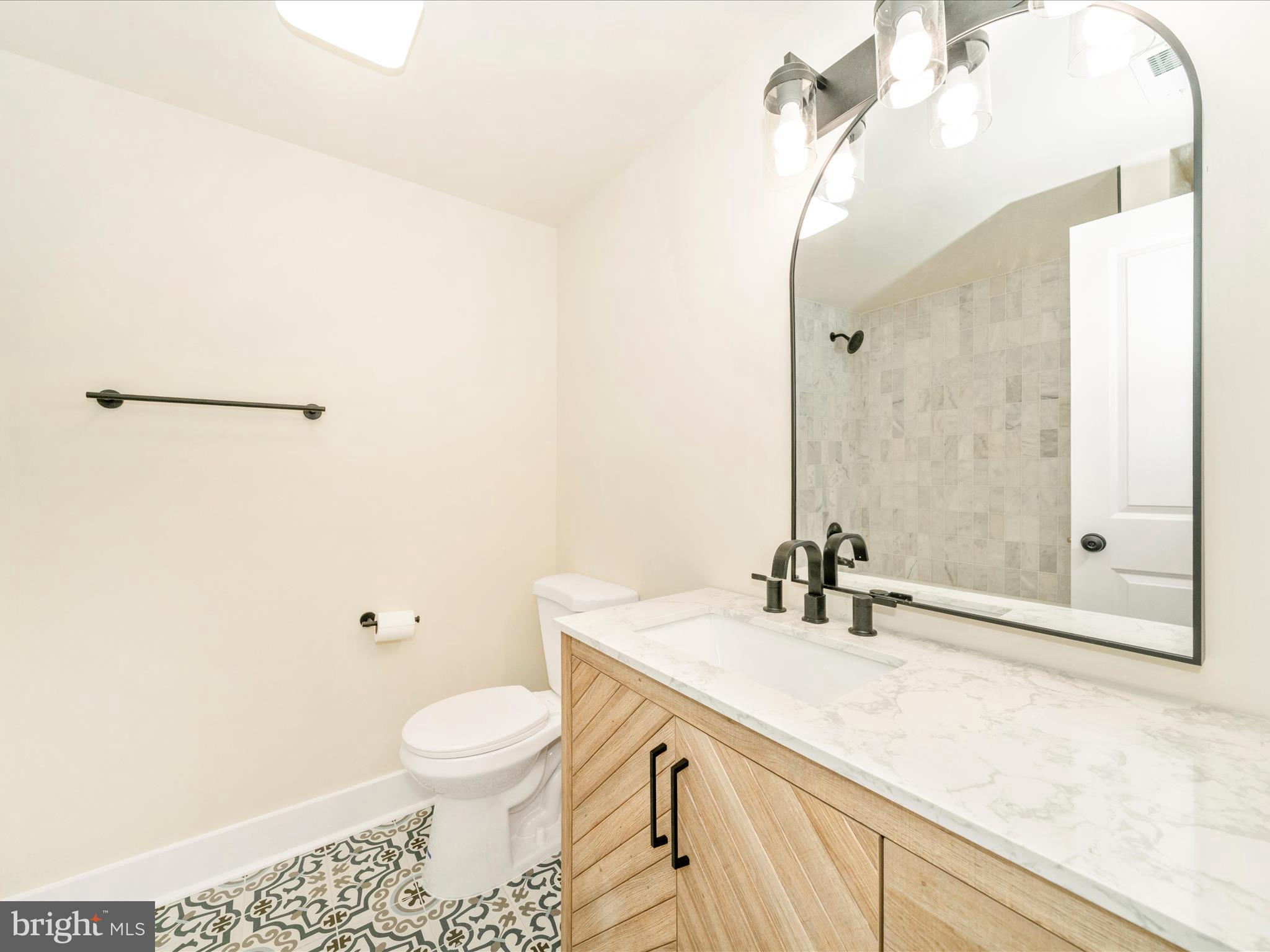 14901 New Windsor Road New Windsor, MD 21776 - Photo 22 of 75 a bathroom with a sink a toilet and a mirror