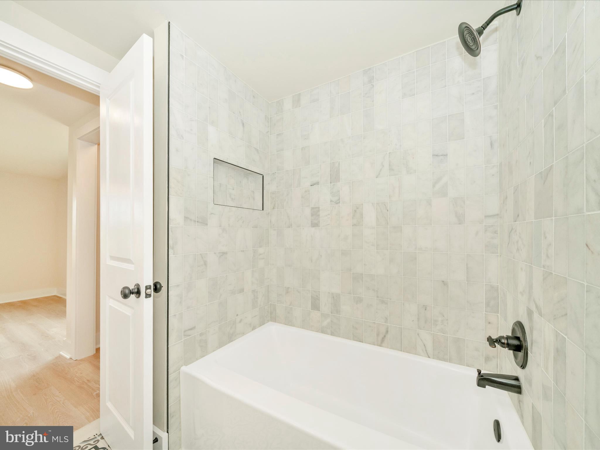 14901 New Windsor Road New Windsor, MD 21776 - Photo 23 of 75 a bathroom with a white bath tub and a shower