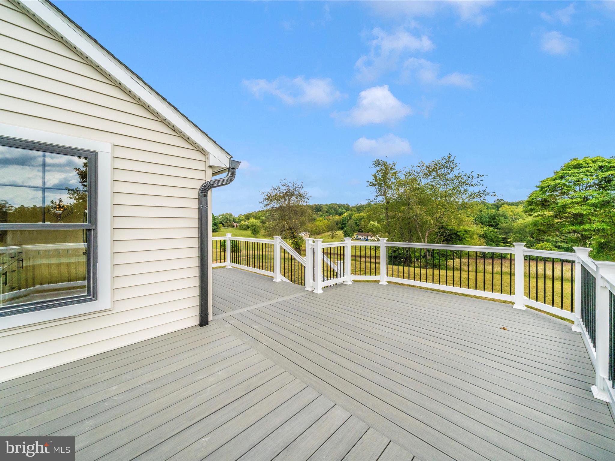 14901 New Windsor Road New Windsor, MD 21776 - Photo 42 of 75 a view of a balcony with wooden floor and fence