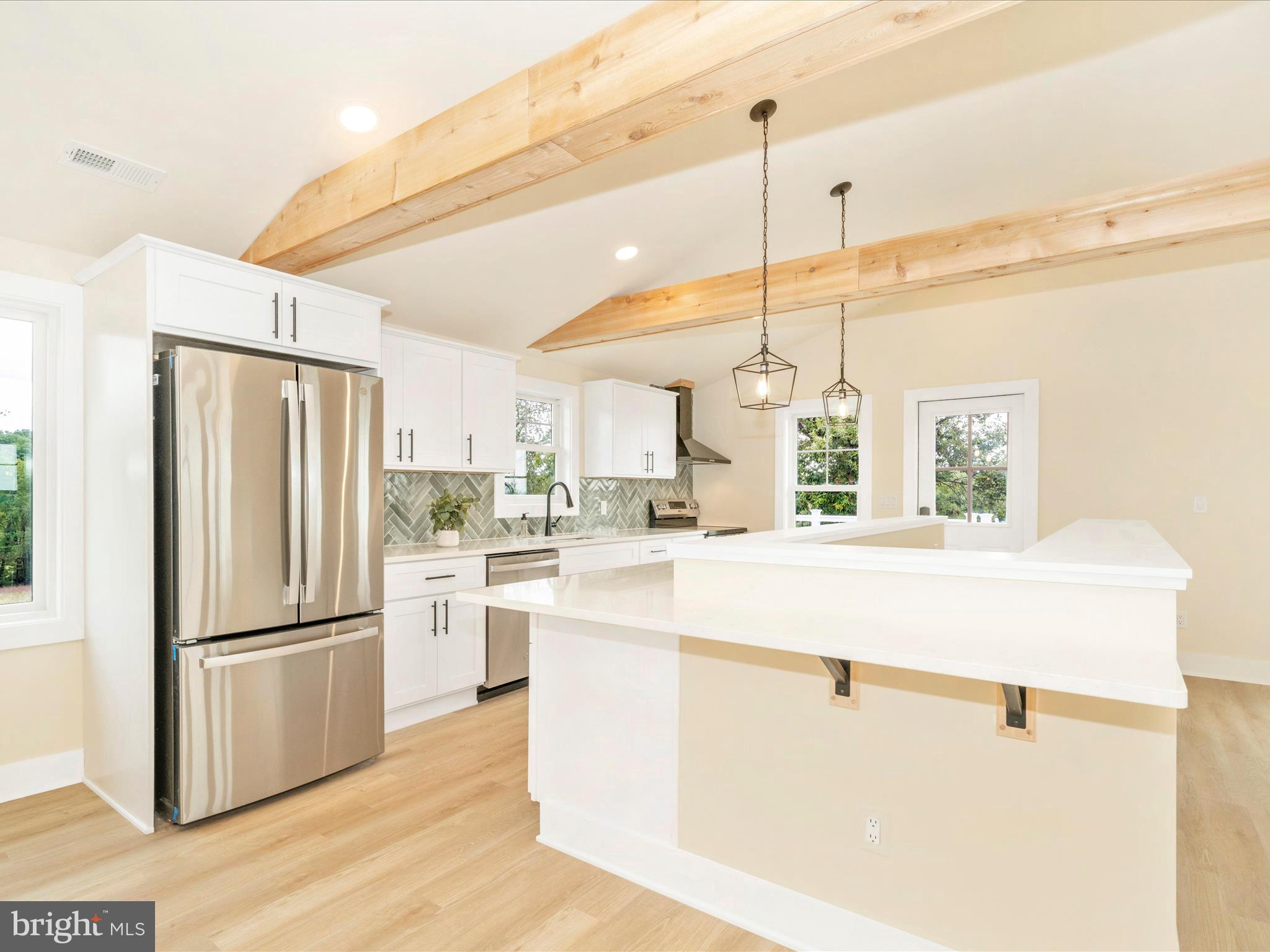 14901 New Windsor Road New Windsor, MD 21776 - Photo 8 of 75 a kitchen with kitchen island a counter top space wooden floor and appliances